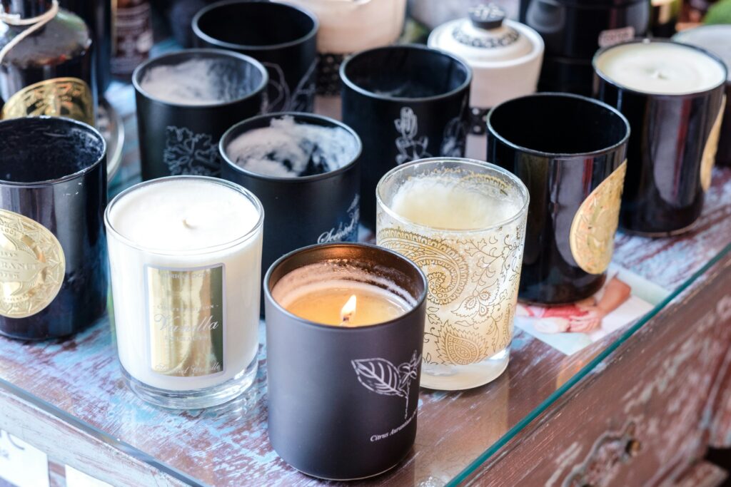 Scented candles in glass containers representing popular holiday scents.