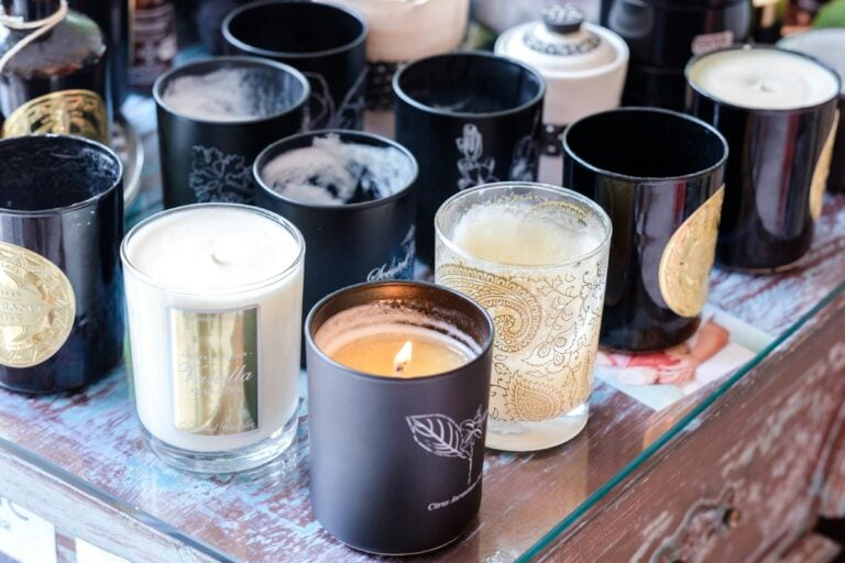 Scented candles in glass containers representing popular holiday scents.